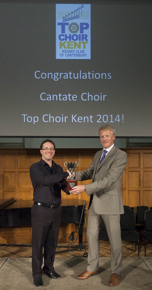 Cantate MD Robin Walker receives the Top Choir Kent Trophy from Rob Smith